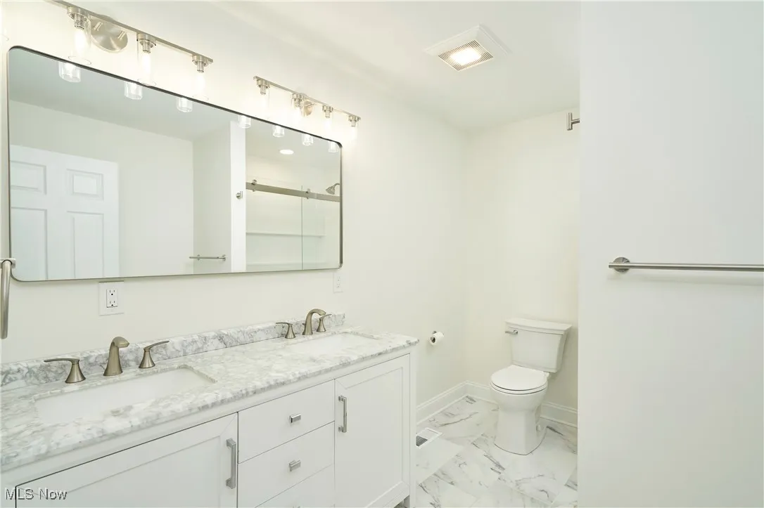 2nd floor bathroom with double sinks and shower