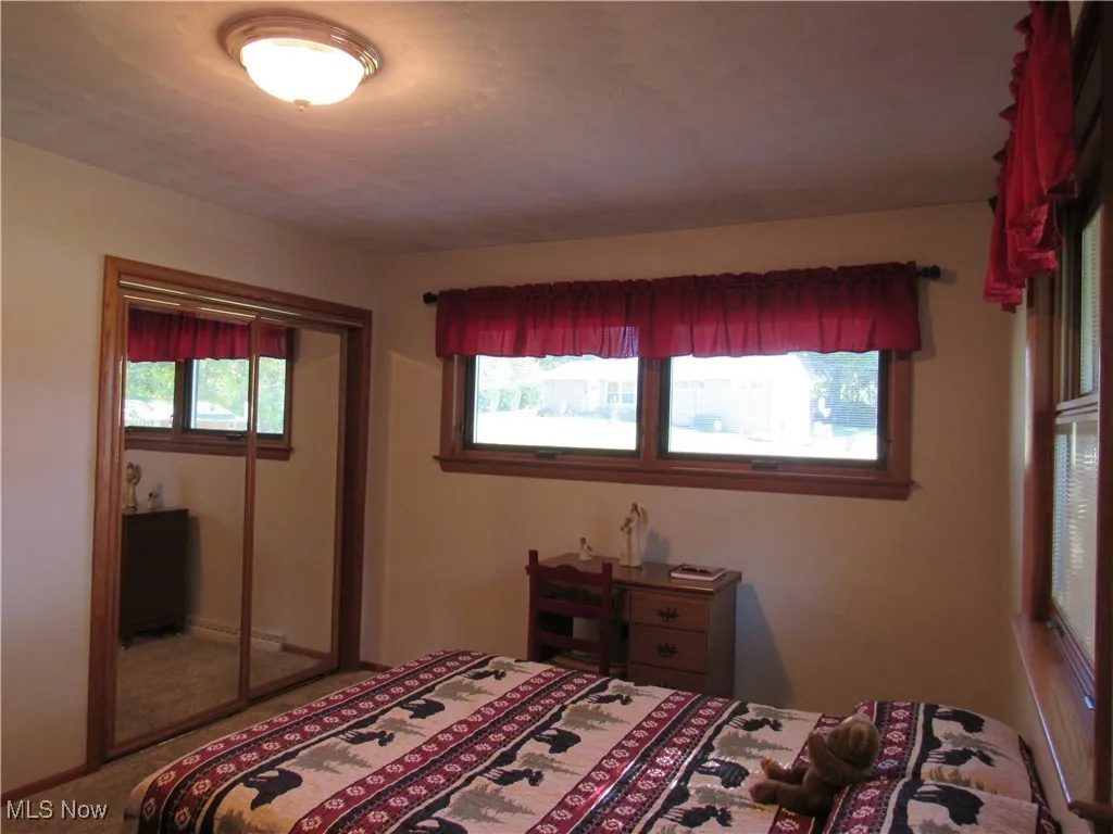 Front Corner Bedroom Carpeted bedroom with a closet