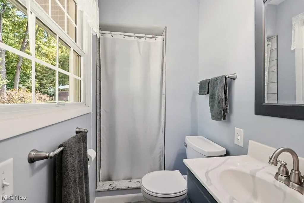Full bathroom with a stall shower and vanity