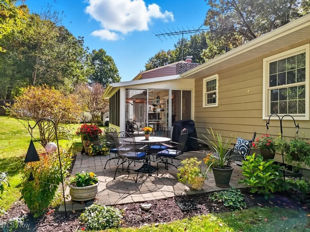 View of patio / terrace with a sunroom, area for grilling, and outdoor dining area