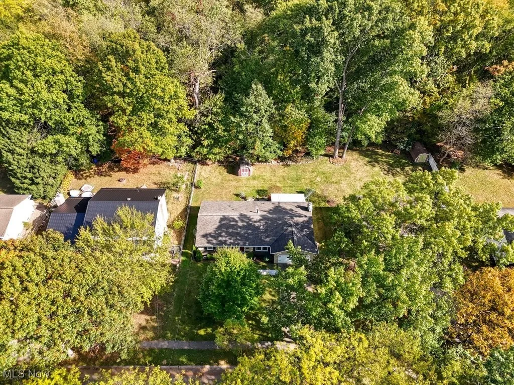 View from above of property featuring a heavily wooded area