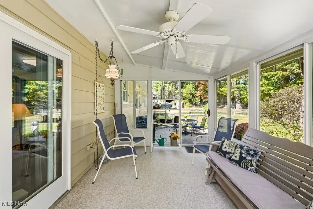 Sunroom featuring ceiling fan, vaulted ceiling, and an outdoor living space