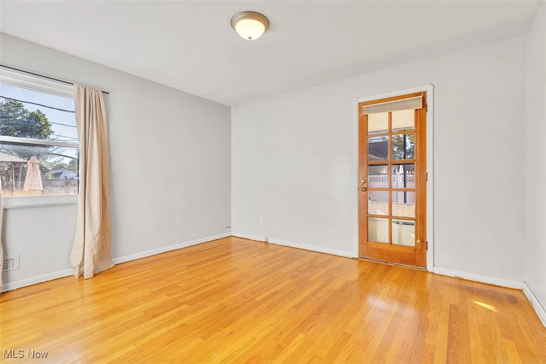 Empty room with baseboards and light wood finished floors