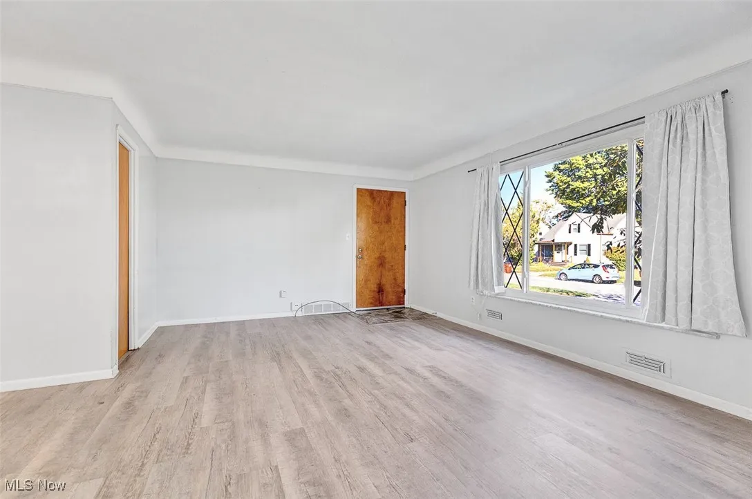 Unfurnished room featuring light wood-style flooring and baseboards
