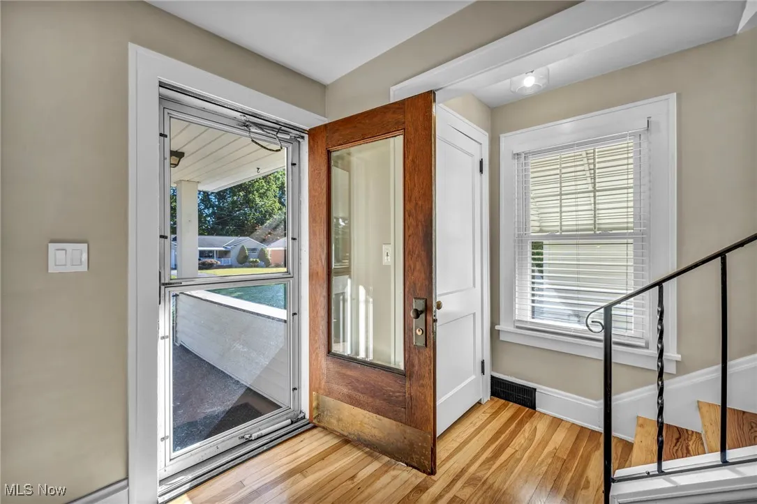 Front doorway entering the home, with hardwood finished floors