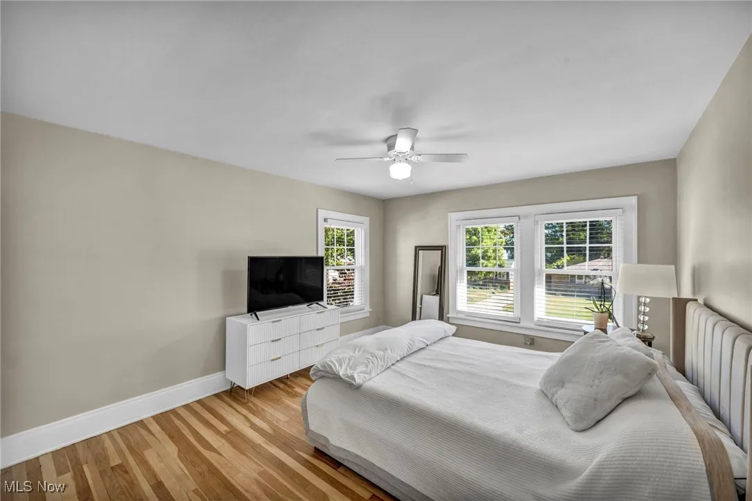 Bedroom with wood finished floors and ceiling fan/