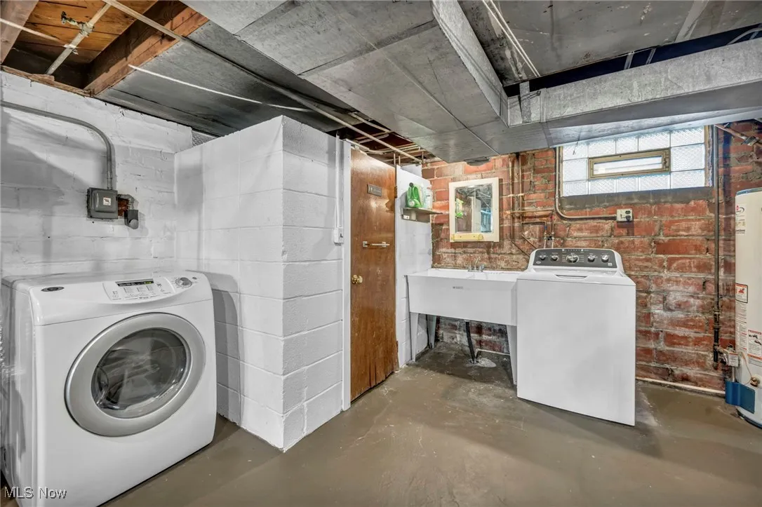 Washroom with washer / dryer, concrete flooring, utility area