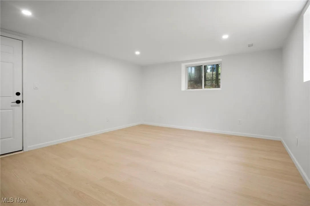 Empty room featuring light wood-style floors and recessed lighting