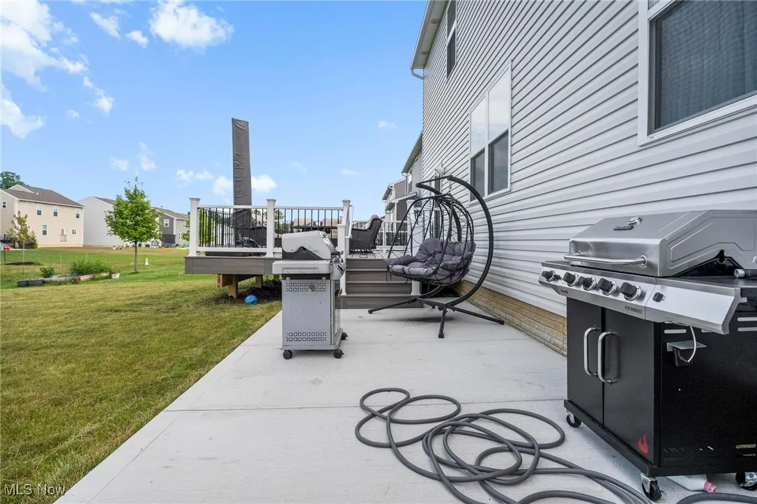 View of patio with grilling area and a deck