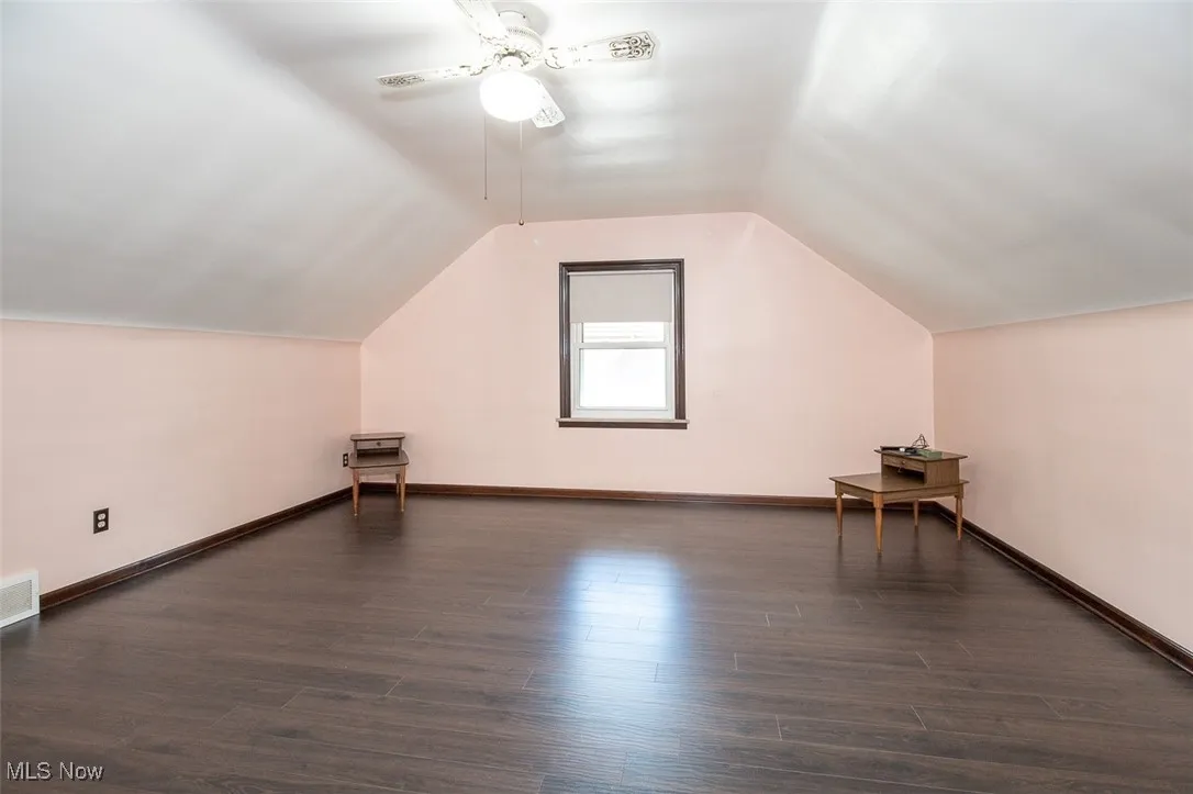 Primary Bedroom featuring wood flooring, lofted ceiling, and ceiling fan.