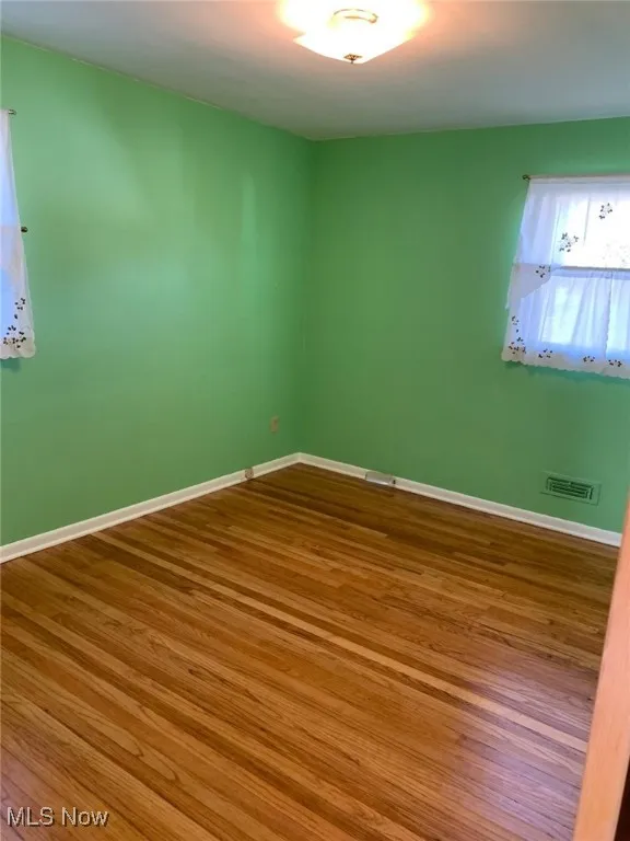 Spare room featuring wood finished floors