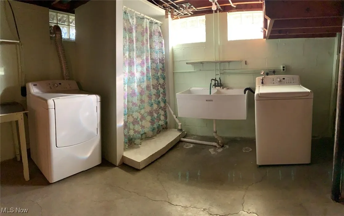 Laundry room with concrete floors and washing machine and dryer