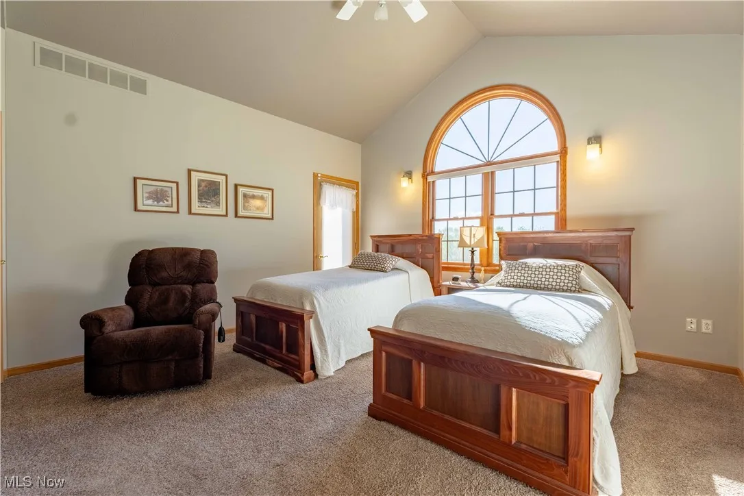 Primary Bedroom with cathedral ceiling and access to outside deck!