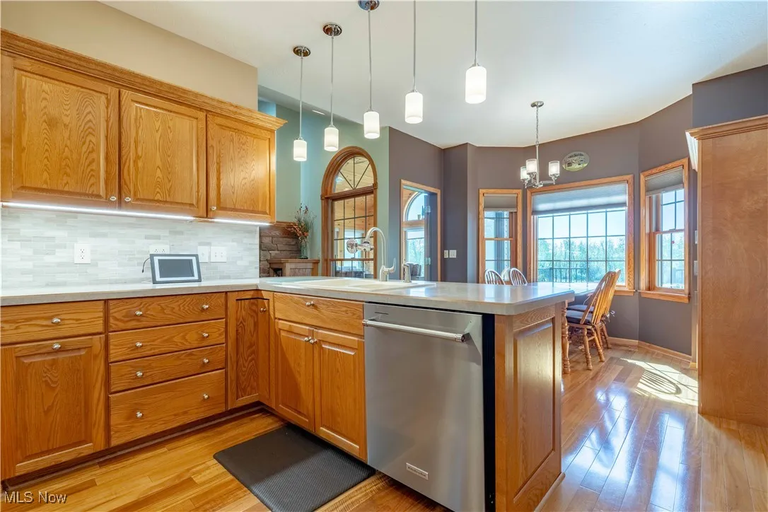Kitchen with updated tile backsplash and hardwood flooring!