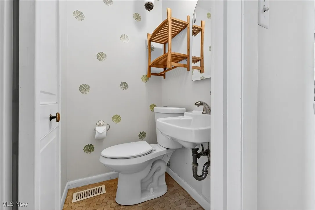 Bathroom with baseboards and light tile patterned floors
