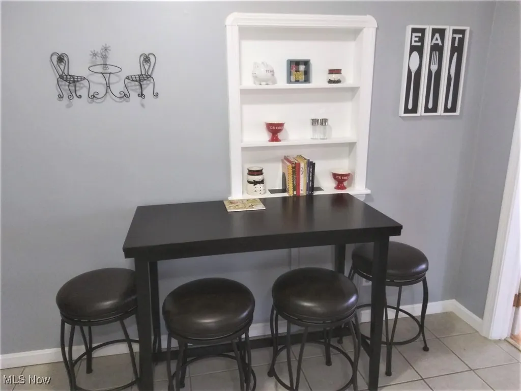 Dining area featuring light tile patterned floors