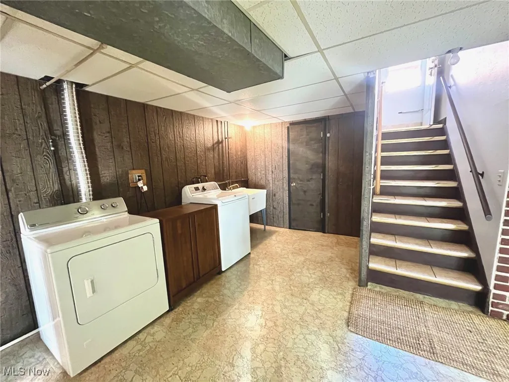 Laundry, water closet and secret door to storage by stairs
