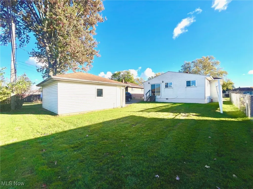 View of yard, back of house and garage