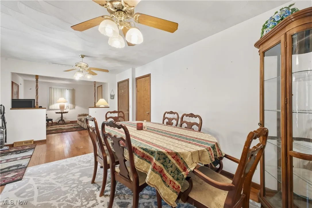 Dining space with wood finished floors and baseboards