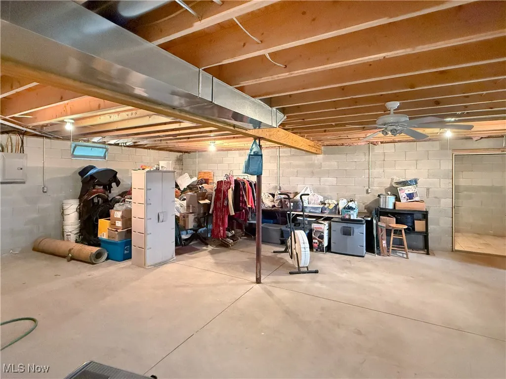Unfinished below grade area featuring electric panel