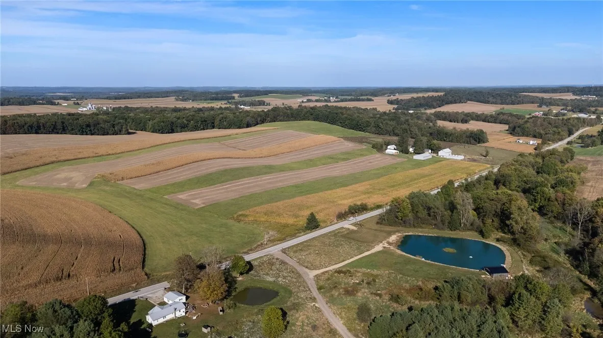View of property location featuring rural landscape, extensive farmland, and a large body of water