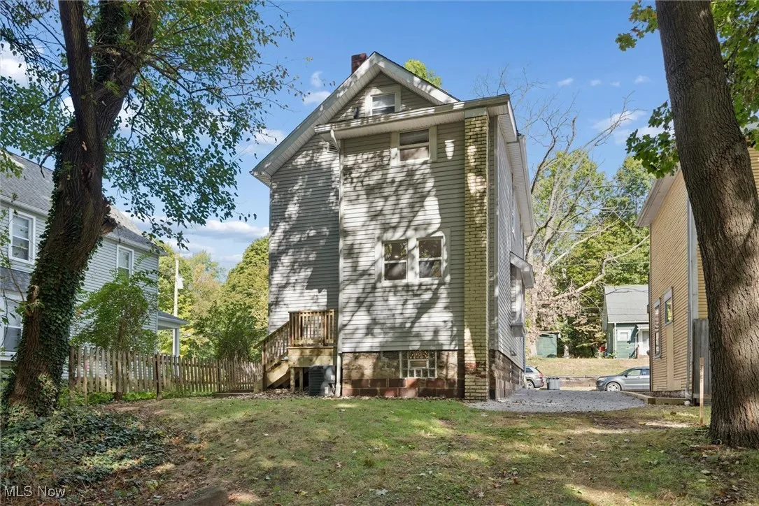 Rear view of house with stairs and a chimney