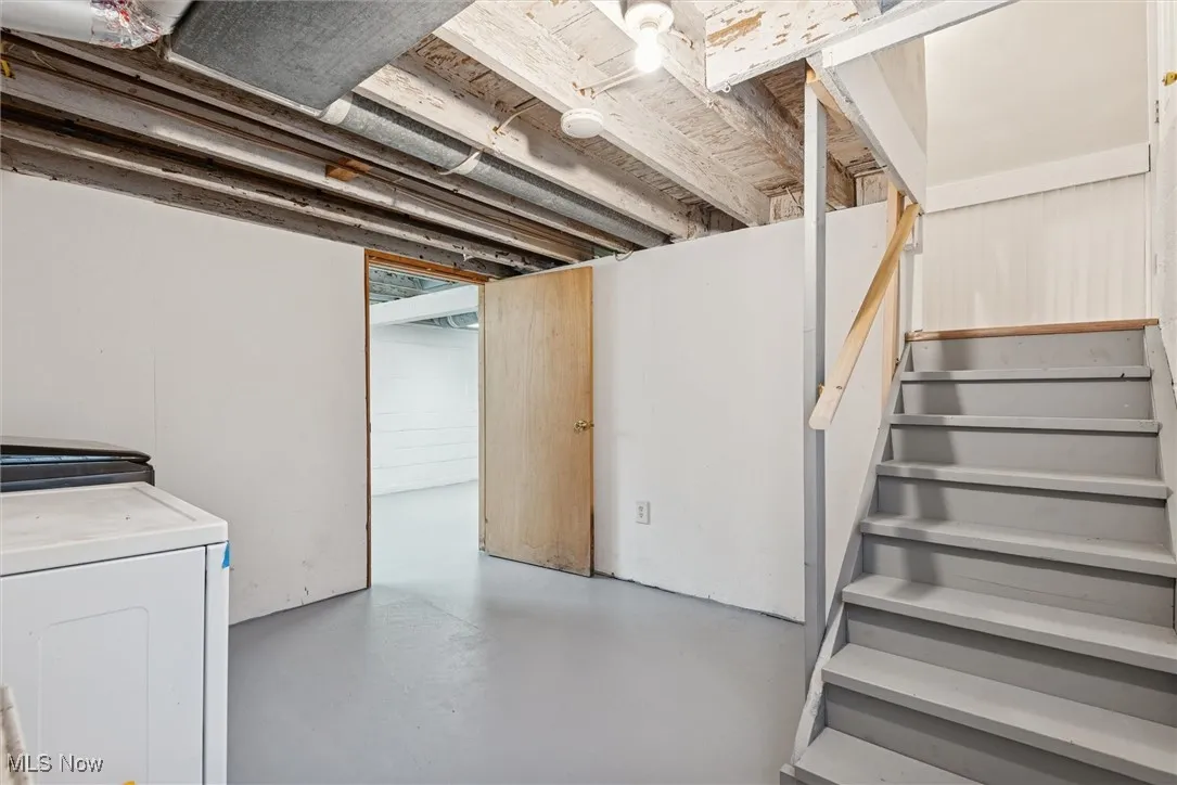 Unfinished basement featuring stairs