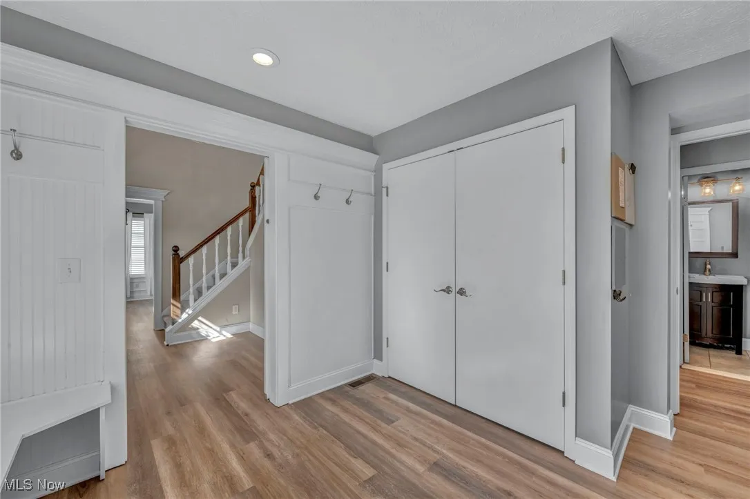 Entryway with light wood-style flooring and stairway