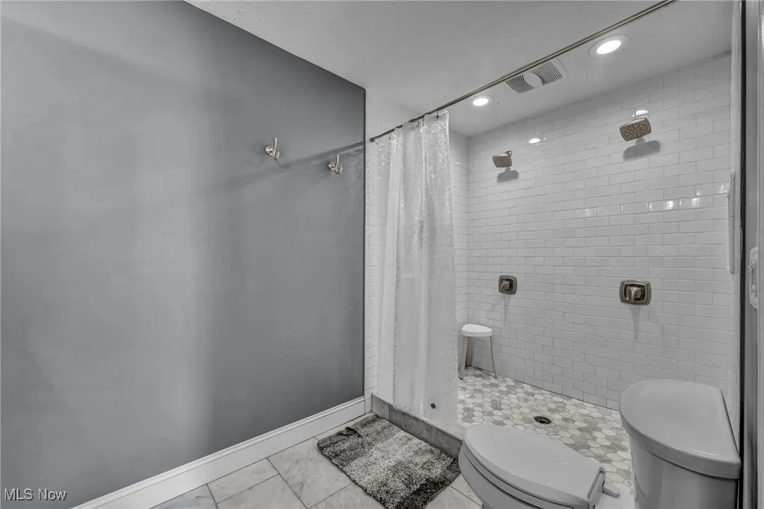 Bathroom featuring a shower stall, recessed lighting, and tile patterned floors