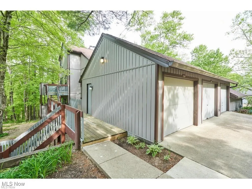 View of outdoor structure with stairway and a garage