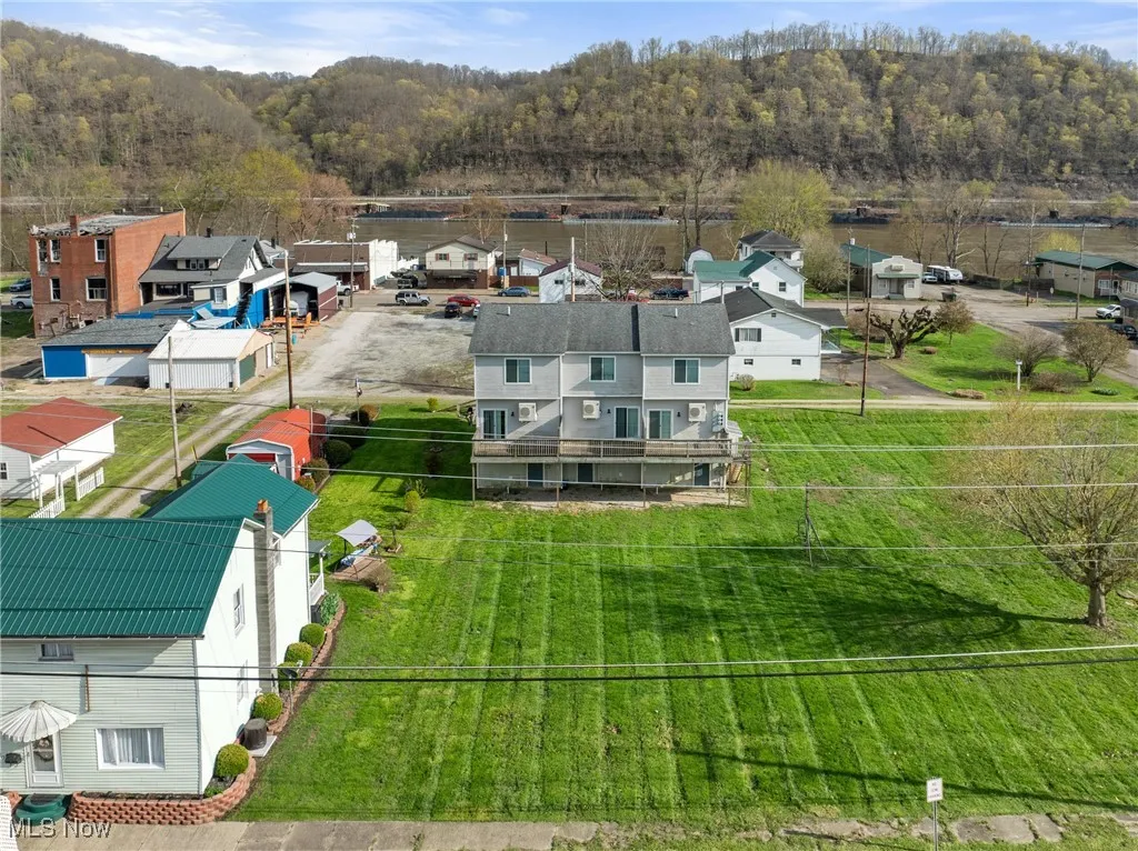 Aerial perspective of suburban area featuring a heavily wooded area