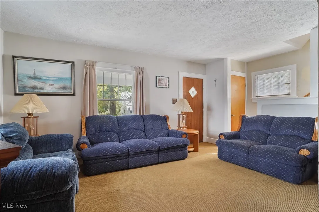 View of the living room from the dining room, looking toward front door.
