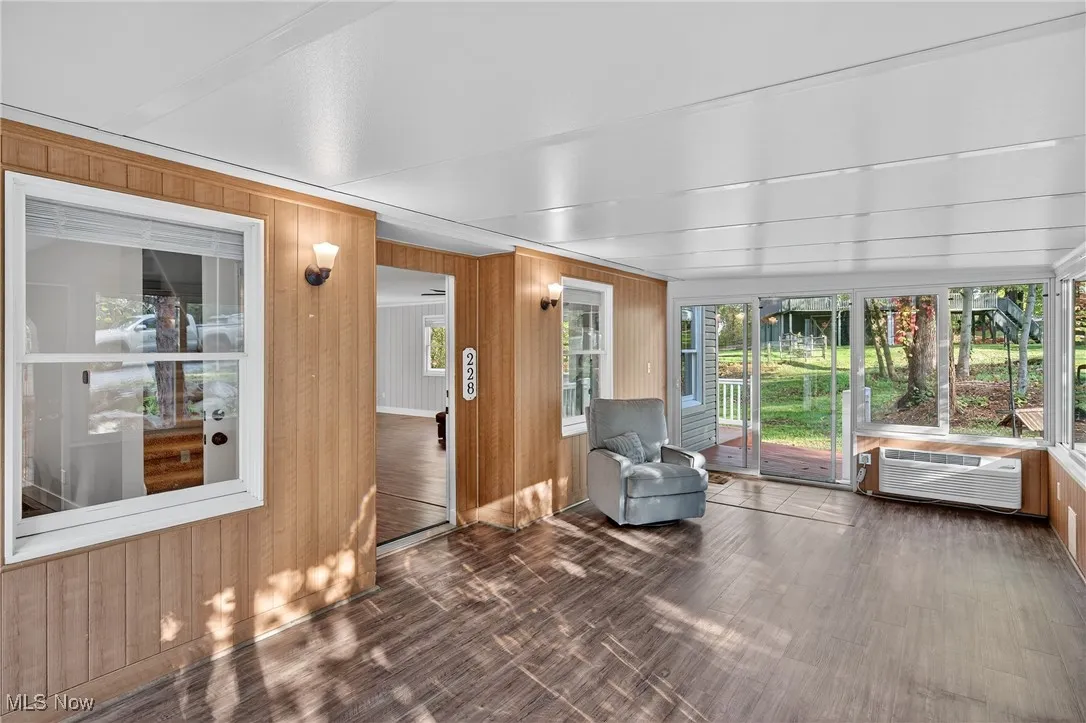 Sunroom with wood walls and wood finished floors