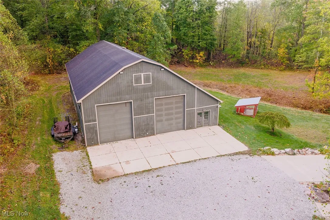 Barn featuring a wooded view