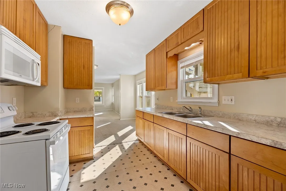 Kitchen featuring white appliances and light countertops