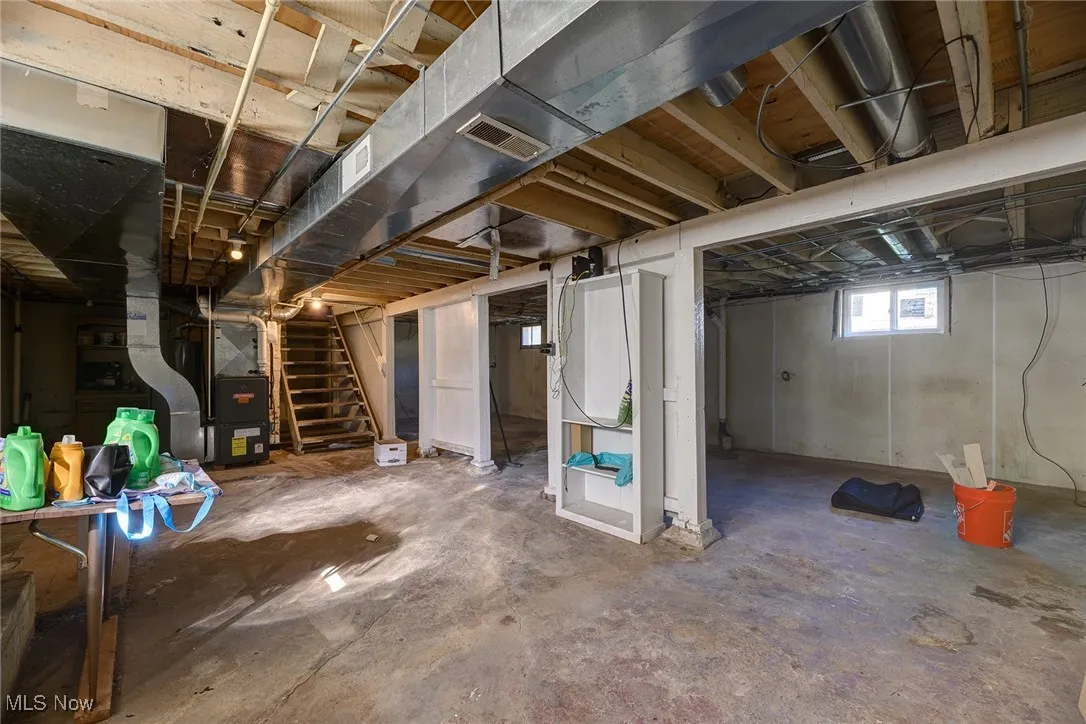 Basement with stairway and heating unit