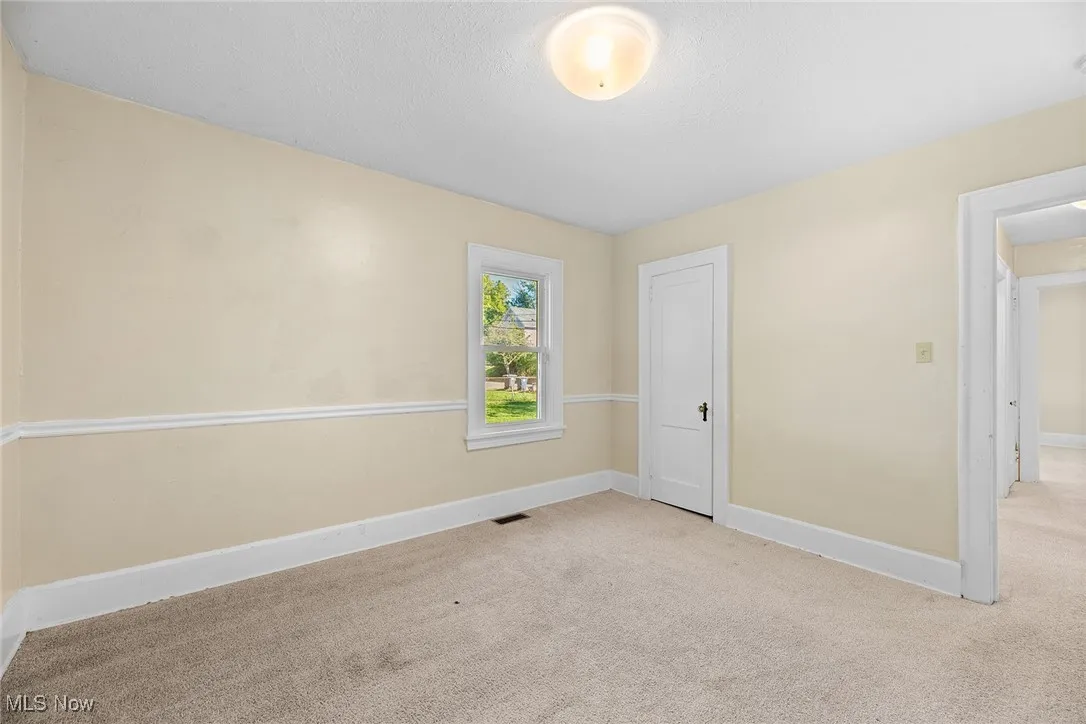 Unfurnished bedroom featuring carpet and a textured ceiling