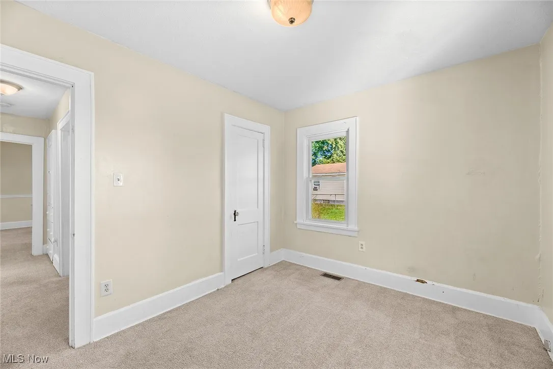 Unfurnished bedroom with light carpet