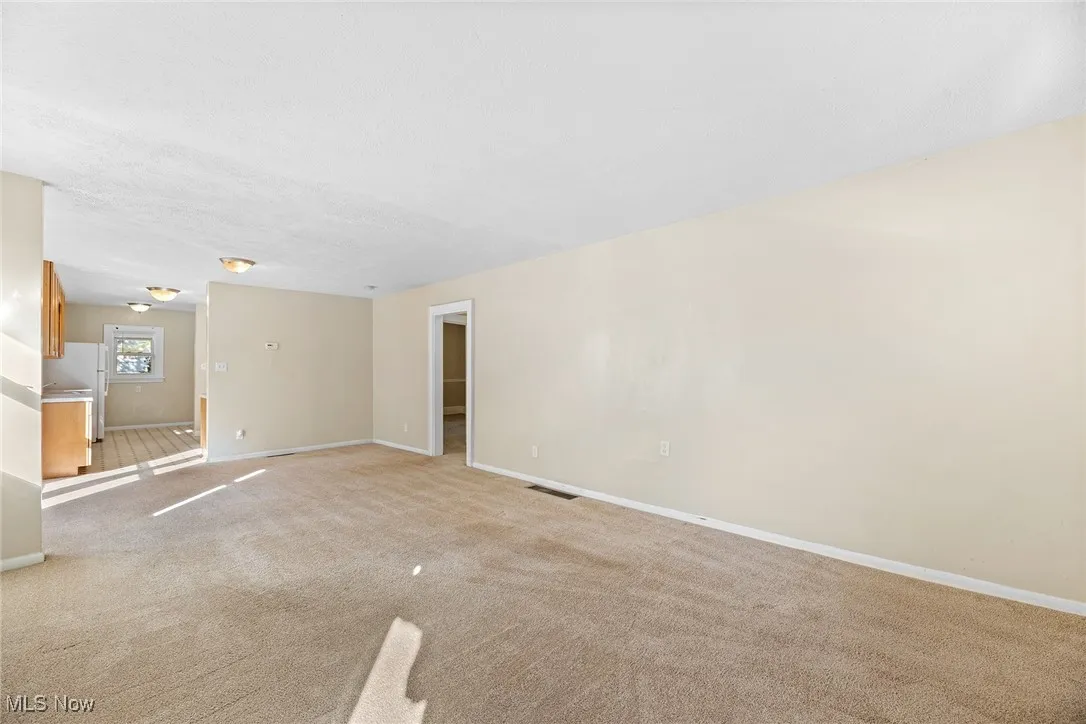 Spare room featuring carpet floors and a textured ceiling