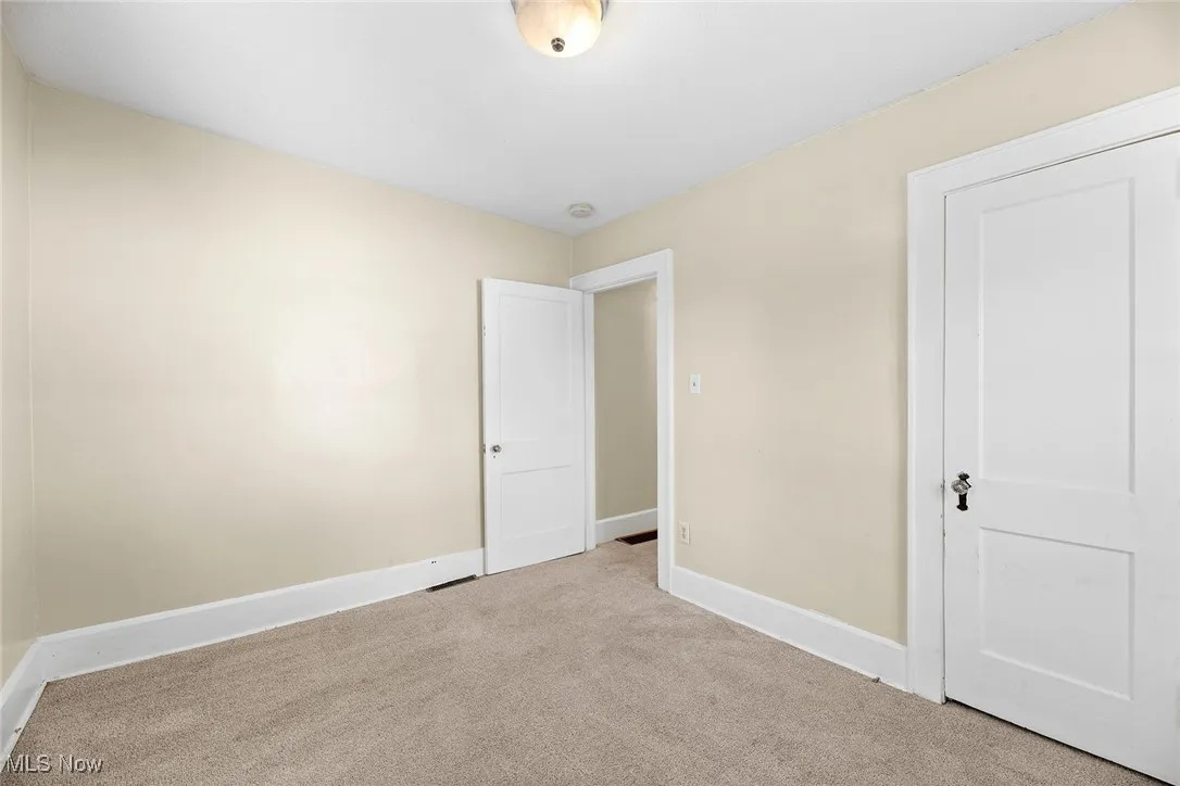 Unfurnished bedroom featuring carpet flooring and baseboards