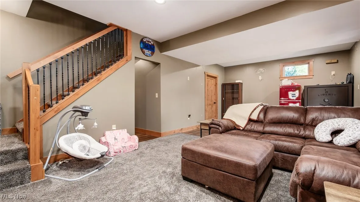 Carpeted living room featuring​​‌​​​​‌​​‌‌​‌‌​​​‌‌​‌​‌​‌​​​‌​​ stairs