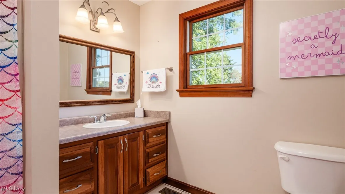 Full bathroom with vanity and toilet
