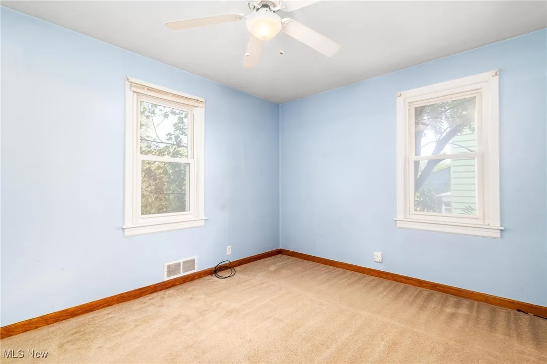 Carpeted empty room with healthy amount of natural light