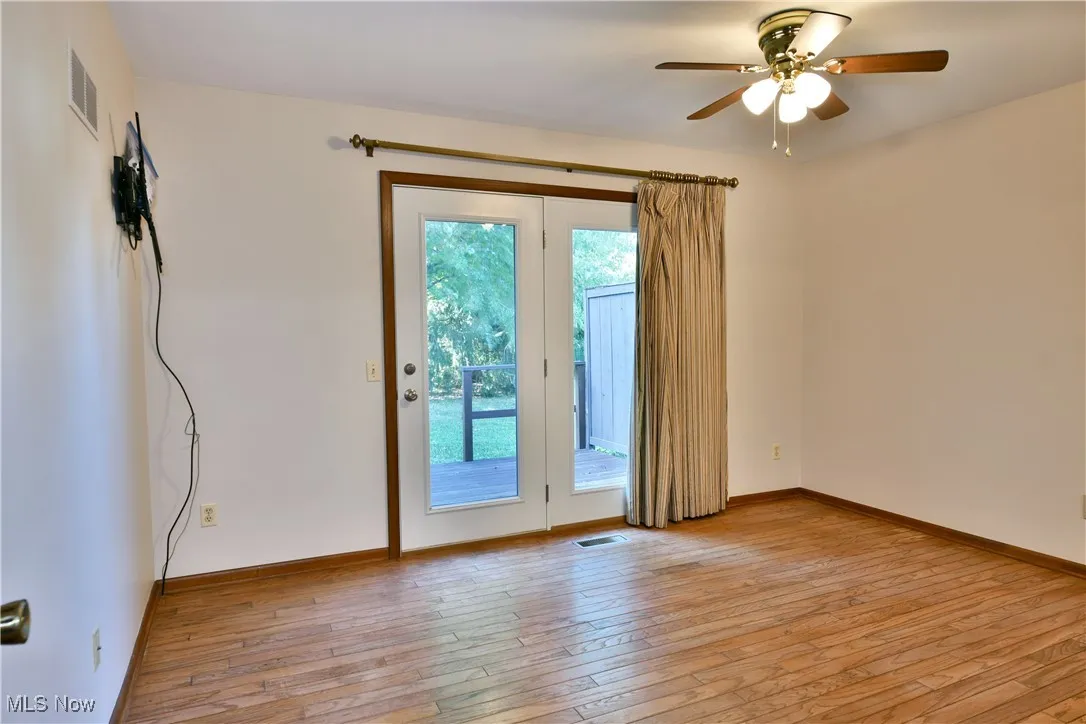 Doorway to outside featuring hardwood / wood-style flooring and a ceiling fan