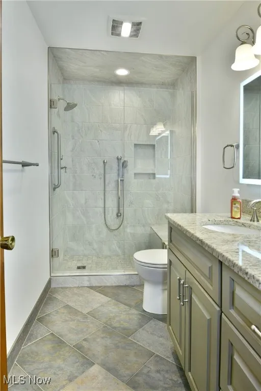 Bathroom featuring vanity and a stall shower