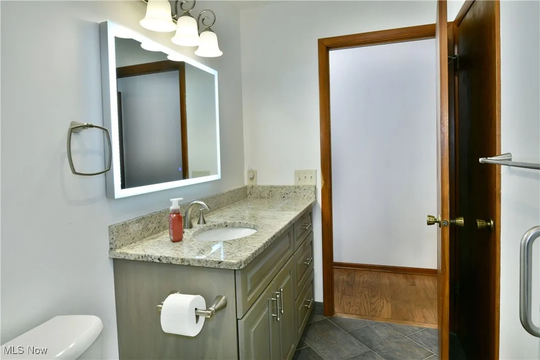 Half bath with vanity and toilet