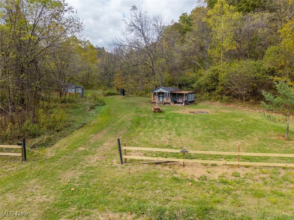 View of yard with a view of countryside, a view of trees, and an outdoor structure