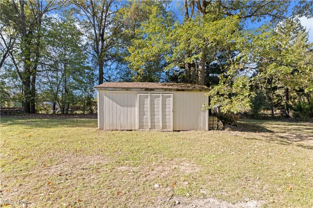 View of shed with view of wooded area