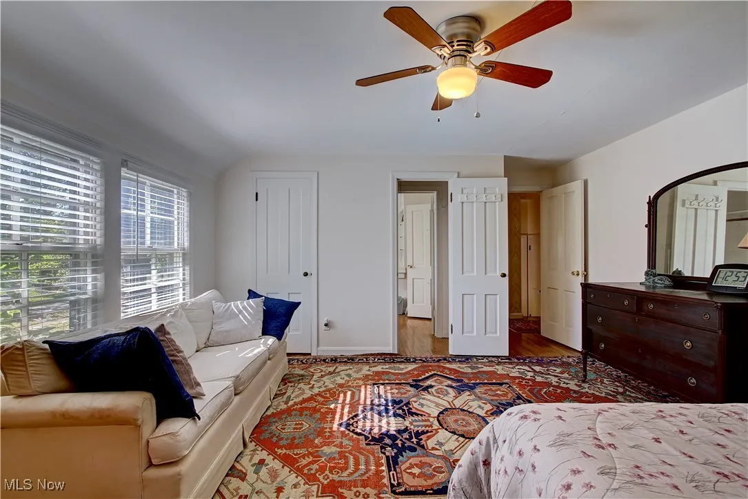 Bedroom featuring wood finished floors, a ceiling fan, and a closet