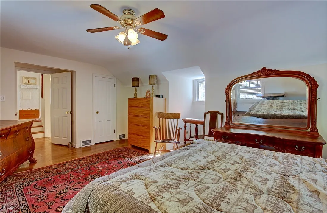 Bedroom featuring wood finished floors, vaulted ceiling, and ceiling fan